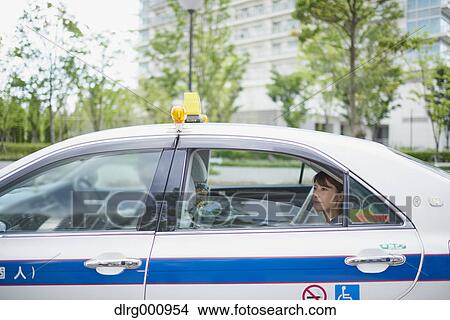 Young Japanese woman riding a taxi downtown Tokyo, Japan View Large Photo Image Picture - Young Japanese woman riding a taxi downtown Tokyo, Japan. Fotosearch
