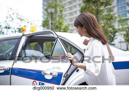 Young Japanese woman riding a taxi downtown Tokyo, Japan View Large Photo Image Stock Image - Young Japanese woman riding a taxi downtown Tokyo, Japan. Fotosearch