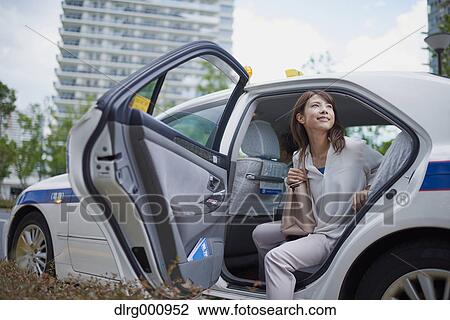 Young Japanese woman riding a taxi downtown Tokyo, Japan View Large Photo Image Stock Image - Young Japanese woman riding a taxi downtown Tokyo, Japan. Fotosearch