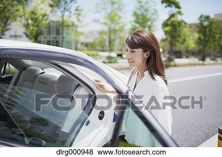Young Japanese woman riding a taxi downtown Tokyo, Japan View Large Photo Image Stock Photo - Young Japanese woman riding a taxi downtown Tokyo, Japan. Fotosearch