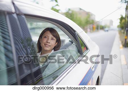 Young Japanese woman riding a taxi downtown Tokyo, Japan View Large Photo Image Stock Photograph - Young Japanese woman riding a taxi downtown Tokyo, Japan. Fotosearch