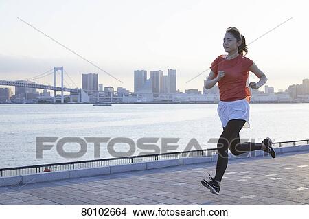 Picture - Young Japanese woman training downtown Tokyo. Fotosearch