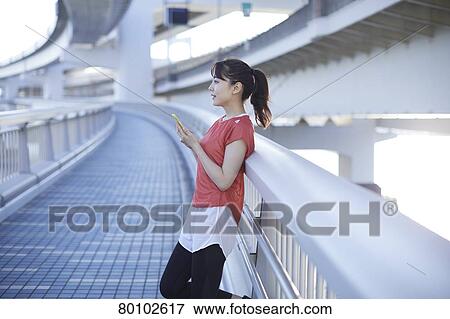 Young Japanese woman training downtown Tokyo View Large Photo Image Stock Photo - Young Japanese woman training downtown Tokyo. Fotosearch