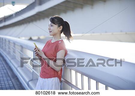Stock Photo - Young Japanese woman training downtown Tokyo. Fotosearch
