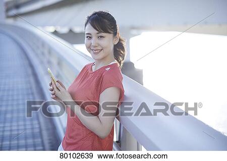 Stock Photo - Young Japanese woman training downtown Tokyo. Fotosearch