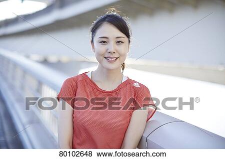 Stock Photo - Young Japanese woman training downtown Tokyo. Fotosearch