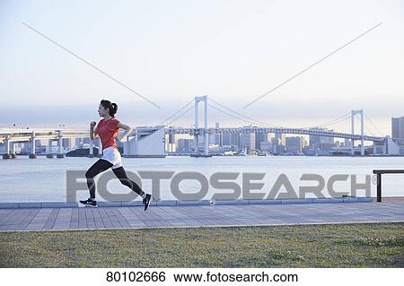 Stock Photograph - Young Japanese woman training downtown Tokyo. Fotosearch