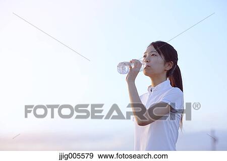 Young Japanese woman training on the beach View Large Photo Image Stock Photo - Young Japanese woman training on the beach. Fotosearch