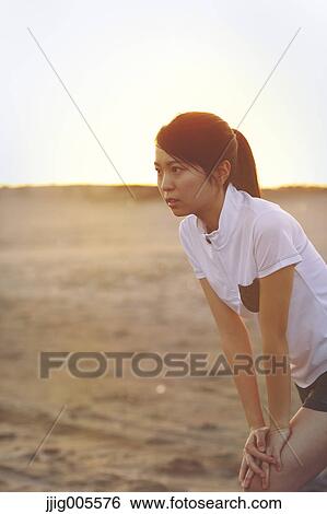 Young Japanese woman training on the beach View Large Photo Image Stock Photograph - Young Japanese woman training on the beach. Fotosearch