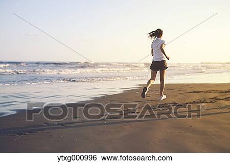 Young Japanese woman training on the beach View Large Photo Image Stock Photograph - Young Japanese woman training on the beach. Fotosearch