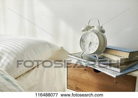 Alarm clock in a bedroom View Large Photo Image Stock Photo - Alarm clock in a bedroom. Fotosearch