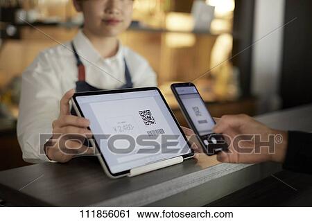 Cashless payment at a restaurant View Large Photo Image Stock Image - Cashless payment at a restaurant. Fotosearch