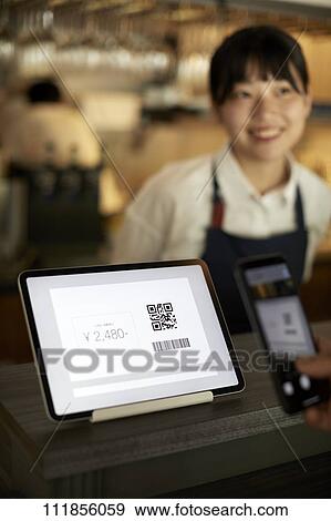 Cashless payment at a restaurant View Large Photo Image Stock Photo - Cashless payment at a restaurant. Fotosearch