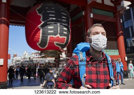 Caucasian tourist wearing a medical mask visiting Tokyo View Large Photo Image Stock Image - Caucasian tourist wearing a medical mask visiting Tokyo. Fotosearch