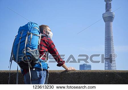 Caucasian tourist wearing a medical mask visiting Tokyo View Large Photo Image Stock Image - Caucasian tourist wearing a medical mask visiting Tokyo. Fotosearch