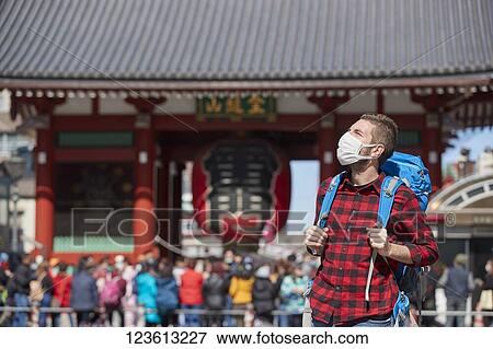 Caucasian tourist wearing a medical mask visiting Tokyo View Large Photo Image Stock Photo - Caucasian tourist wearing a medical mask visiting Tokyo. Fotosearch