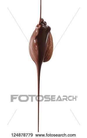 Stock Photo - Chocolate pouring over almond. Fotosearch