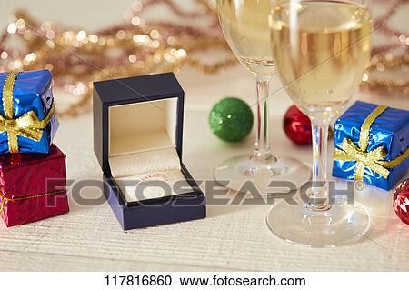 Stock Image - Diamond ring and sparkling wine. Fotosearch