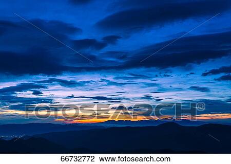 Stock Image - Dramatic sunrise clouds. Fotosearch