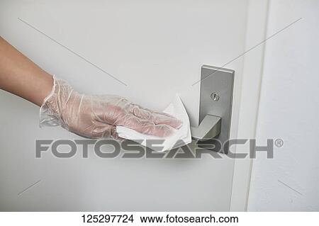Japan man disinfecting door knob with alcohol View Large Photo Image Picture - Japan man disinfecting door knob with alcohol. Fotosearch