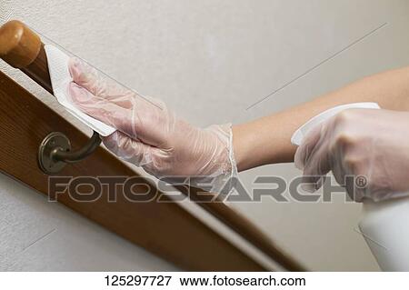 Japan man disinfecting staircase handrail with alcohol View Large Photo Image Stock Photo - Japan man disinfecting staircase handrail with alcohol. Fotosearch