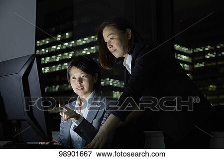 Japanese business people working late at night View Large Photo Image Stock Photo - Japanese business people working late at night. Fotosearch