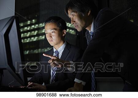 Japanese business people working late at night View Large Photo Image Stock Photo - Japanese business people working late at night. Fotosearch