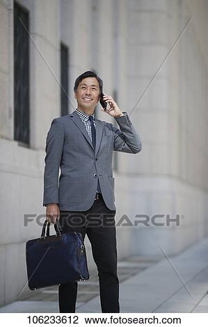 Stock Image - Japanese businessman downtown. Fotosearch