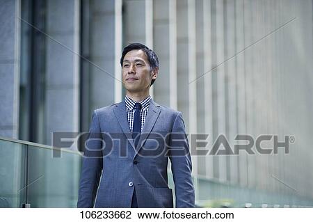 Stock Image - Japanese businessman downtown. Fotosearch