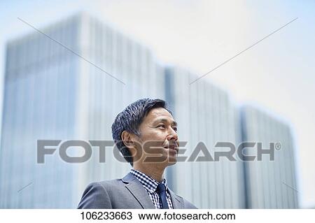 Stock Image - Japanese businessman downtown. Fotosearch