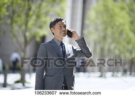 Stock Photo - Japanese businessman downtown. Fotosearch