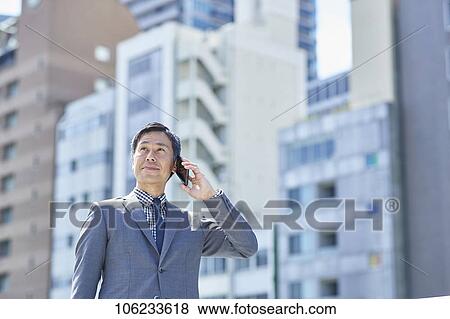 Stock Photo - Japanese businessman downtown. Fotosearch