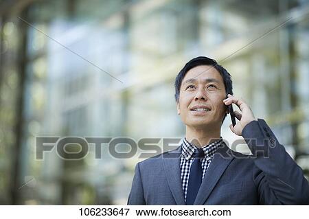 Stock Photo - Japanese businessman downtown. Fotosearch