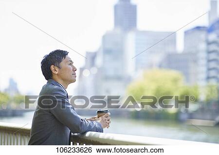 Stock Photograph - Japanese businessman downtown. Fotosearch