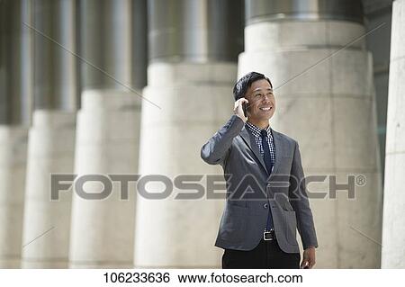Stock Photograph - Japanese businessman downtown. Fotosearch