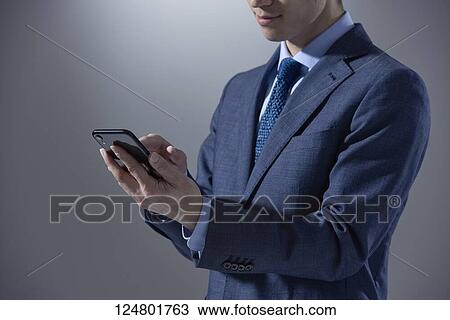 Stock Image - Japanese businessman studio portrait. Fotosearch