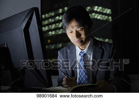 Japanese businessman working late at night View Large Photo Image Picture - Japanese businessman working late at night. Fotosearch