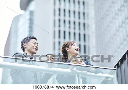 Picture - Japanese businesspeople downtown. Fotosearch