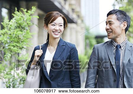 Stock Photo - Japanese businesspeople downtown. Fotosearch