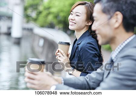 Stock Photo - Japanese businesspeople downtown. Fotosearch