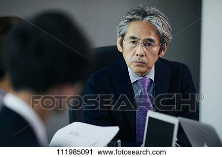 Japanese businesspeople having a meeting View Large Photo Image Stock Image - Japanese businesspeople having a meeting. Fotosearch