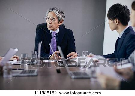 Japanese businesspeople having a meeting View Large Photo Image Stock Image - Japanese businesspeople having a meeting. Fotosearch