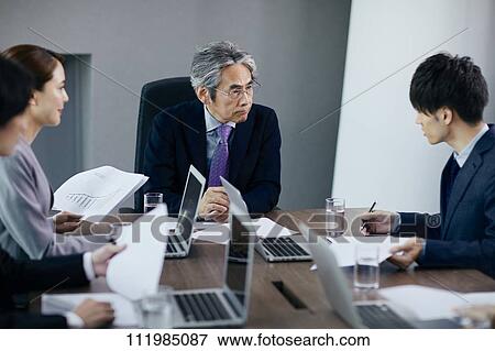 Japanese businesspeople having a meeting View Large Photo Image Stock Photo - Japanese businesspeople having a meeting. Fotosearch