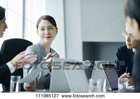 Japanese businesspeople having a meeting View Large Photo Image Stock Photo - Japanese businesspeople having a meeting. Fotosearch
