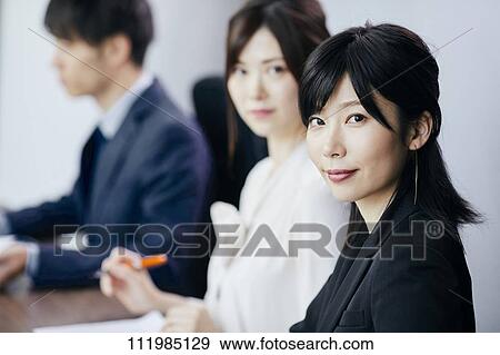 Japanese businesspeople having a meeting View Large Photo Image Stock Photo - Japanese businesspeople having a meeting. Fotosearch