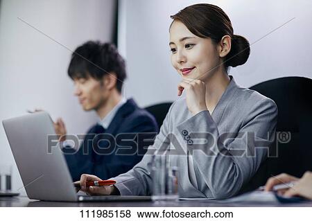 Stock Photo - Japanese businesspeople having a meeting. Fotosearch