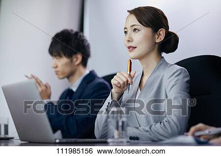 Stock Photograph - Japanese businesspeople having a meeting. Fotosearch