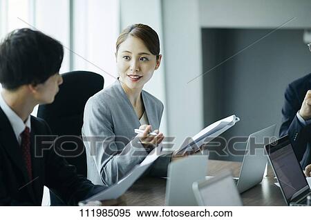 Stock Photography - Japanese businesspeople having a meeting. Fotosearch