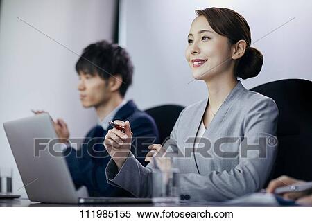 Stock Photography - Japanese businesspeople having a meeting. Fotosearch