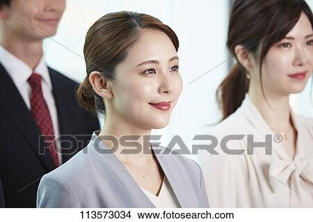 Picture - Japanese businesspeople in a meeting. Fotosearch